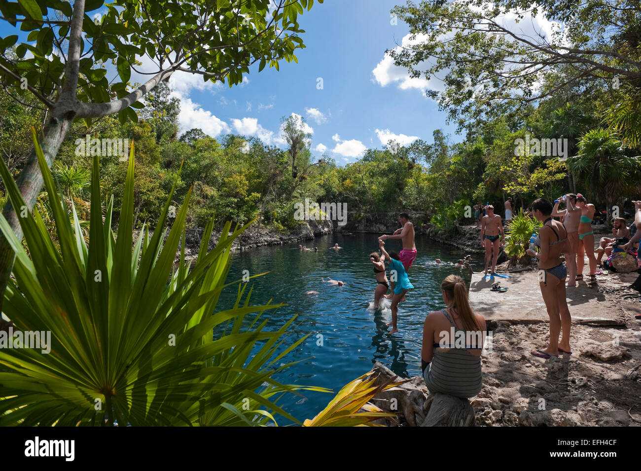 Horizontal view of tourists enjoying the cool water at Cueva de los Peces (Fish Cave) in Cuba. Stock Photo