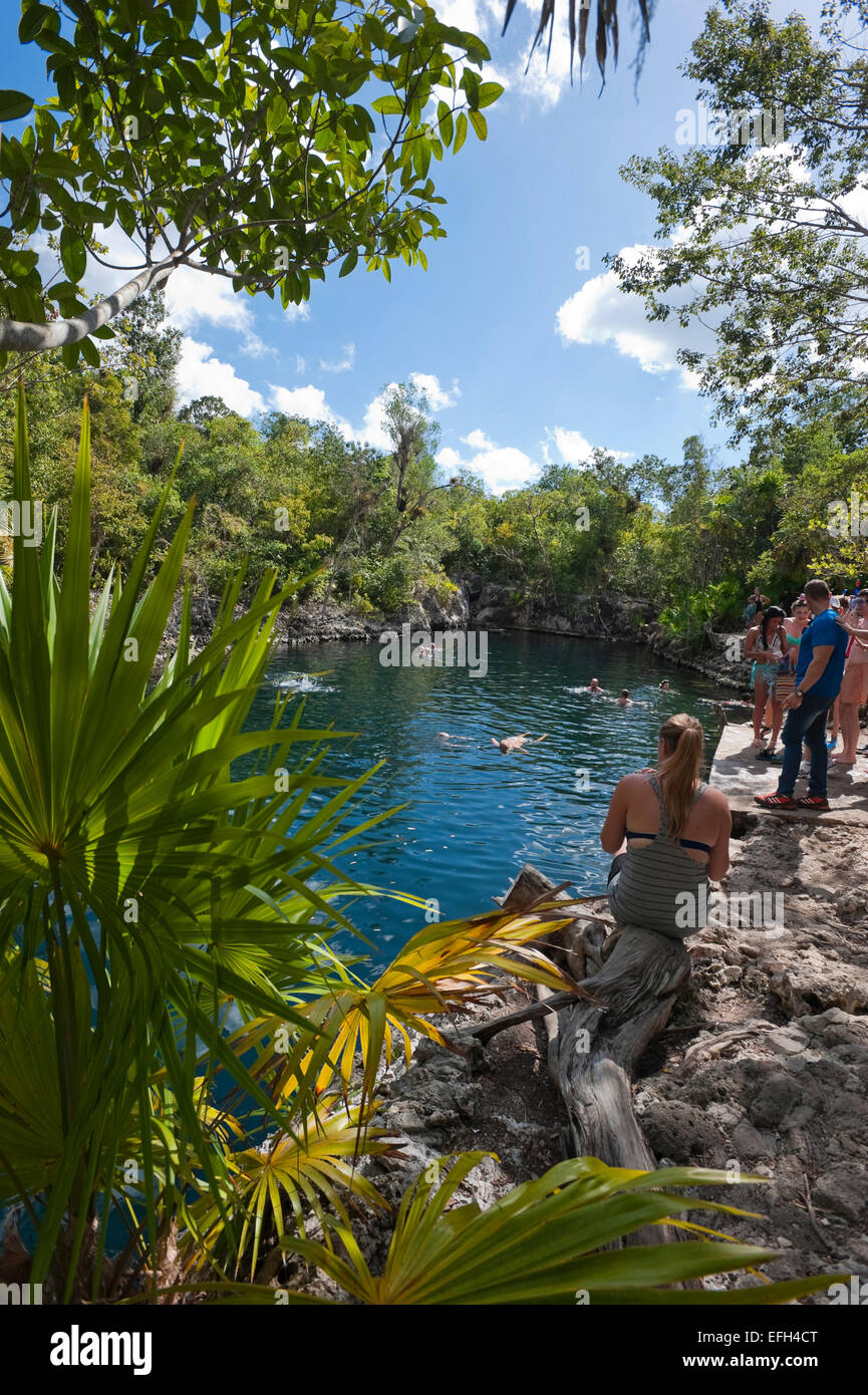 Vertical view of tourists enjoying the cool water at Cueva de los Peces (Fish Cave) in Cuba. Stock Photo