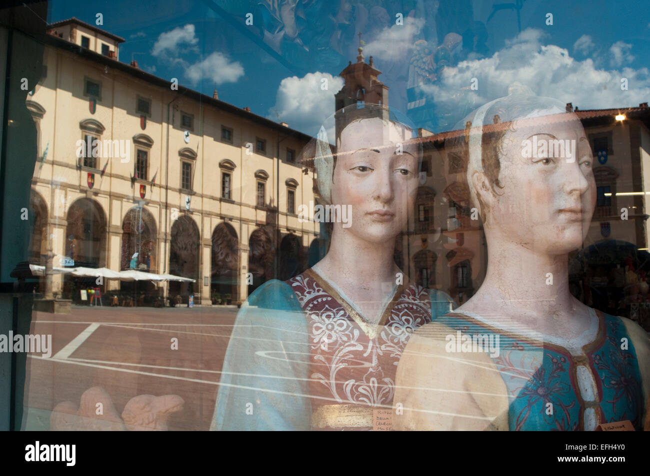 Italy, Tuscany, Arezzo, Piazza Grande Square Reflected in the Window Shop Stock Photo