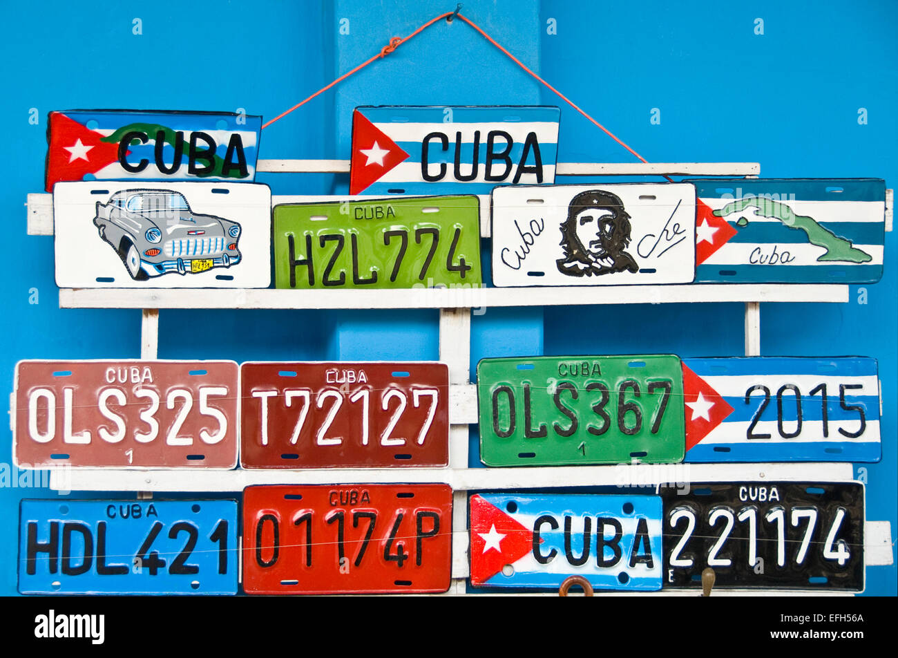 Horizontal close up of colourful metallic number plates for sale in Cuba. Stock Photo