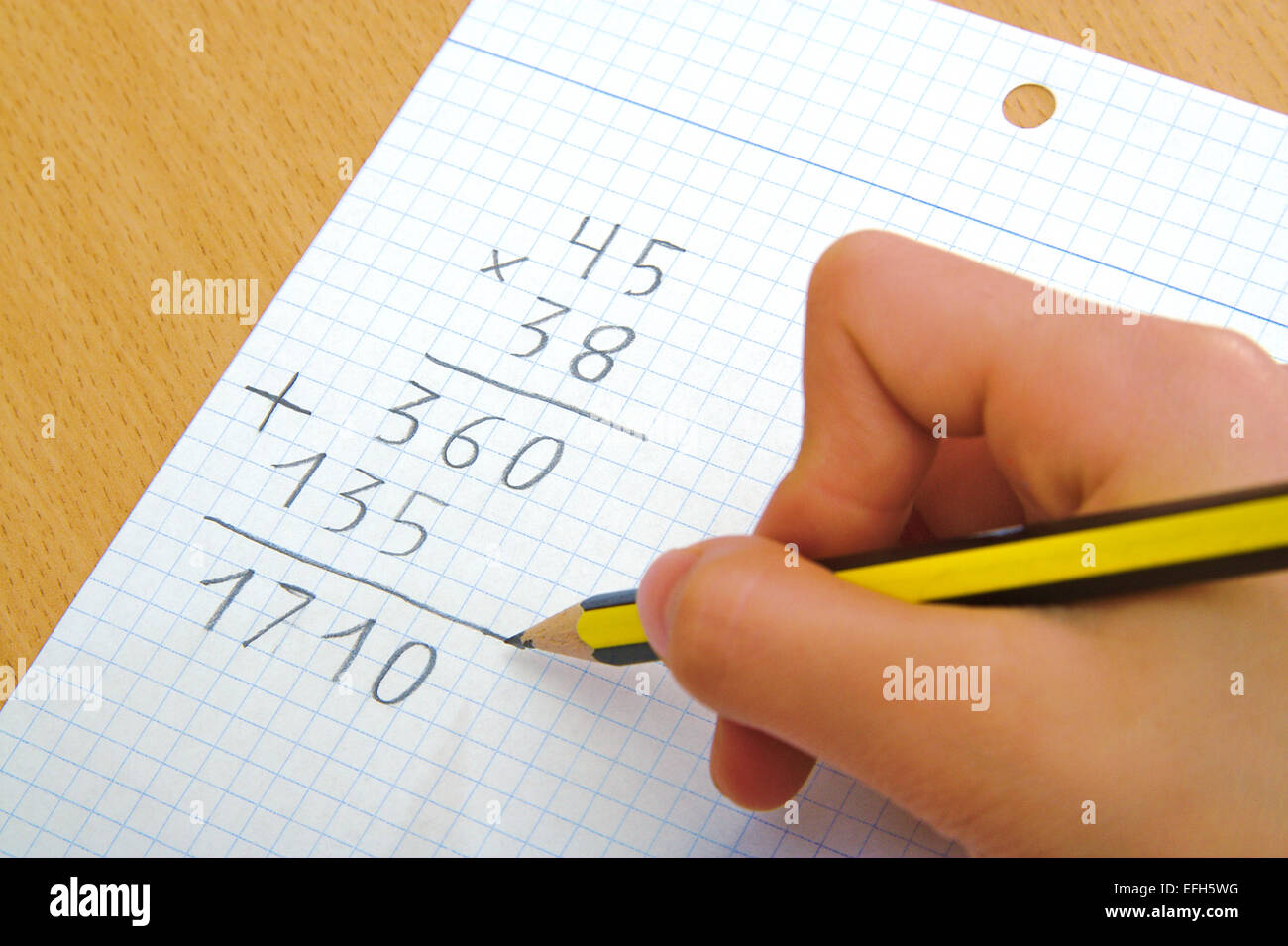 Child doing a math multiplication at school Stock Photo
