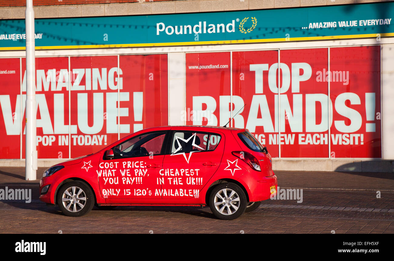 'Top Brands' Bus  Red Hyundai ix20 Hatchback advertising outside Poundland, Blackpool, UK Stock Photo