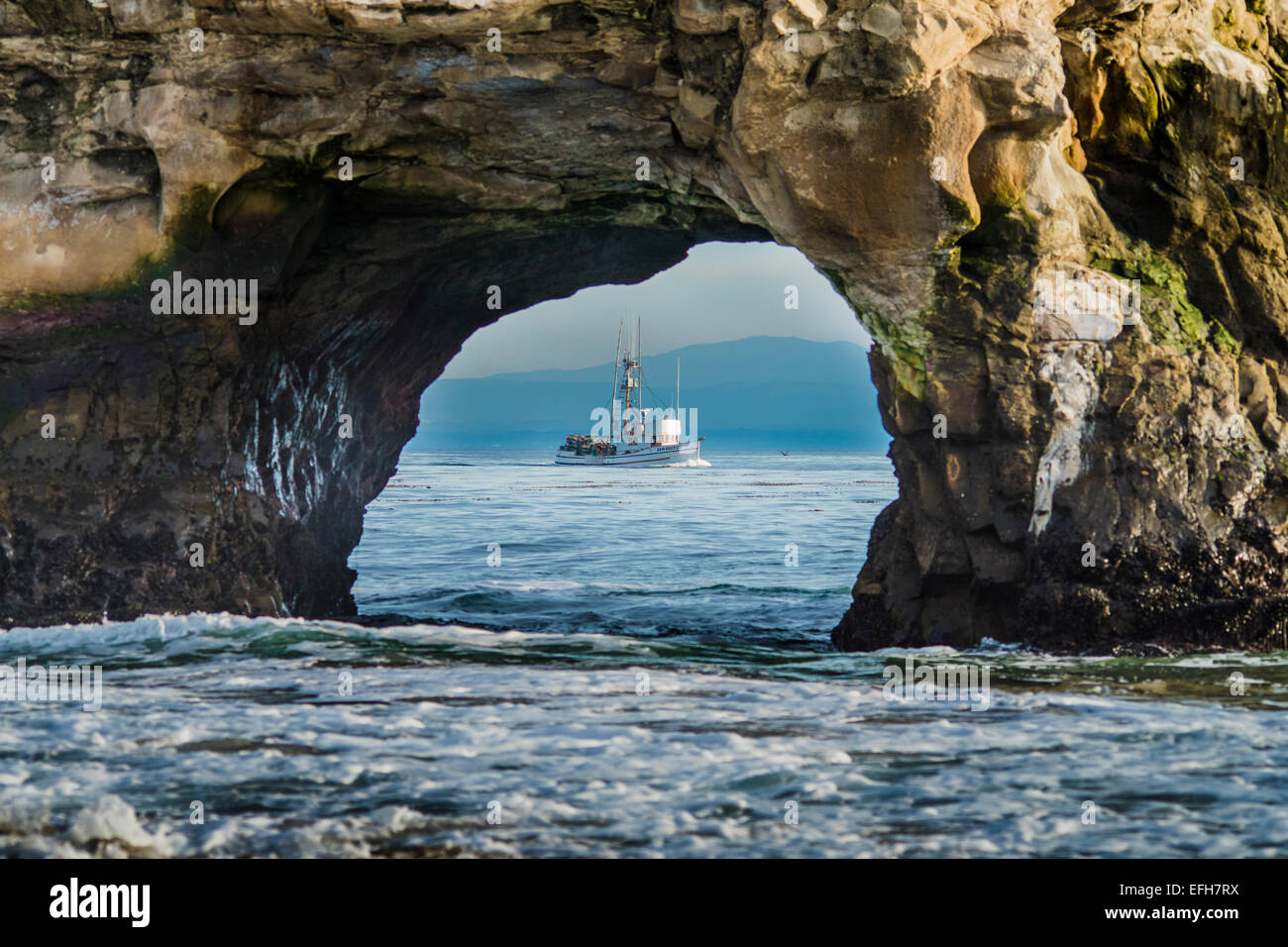 Fishing boat going out to work Stock Photo