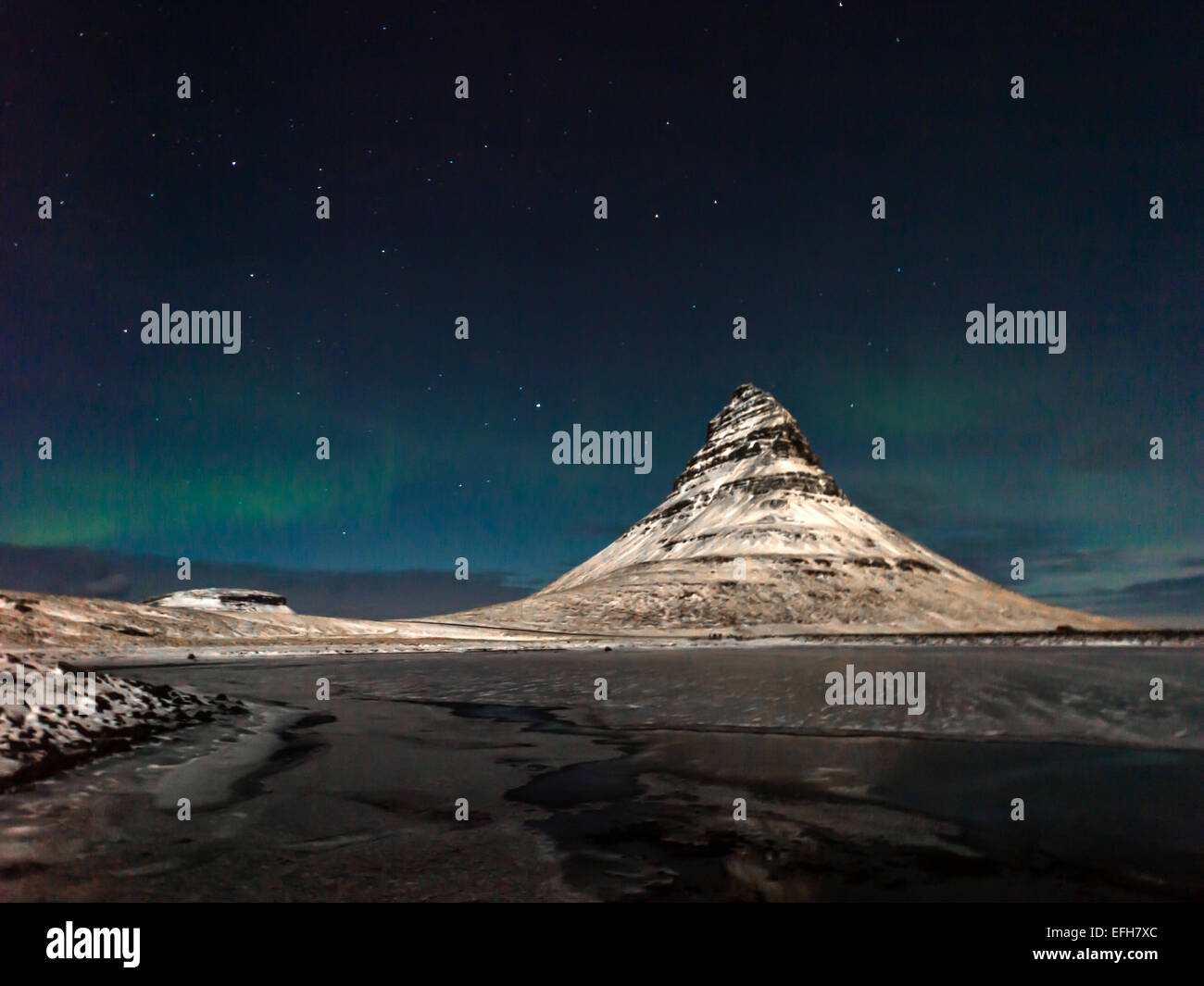 Icelandic scene depicting Kirkjufell and the stars in the northern hemisphere at night. Kirkjufellsa, Grundarfjordur, Iceland. Stock Photo
