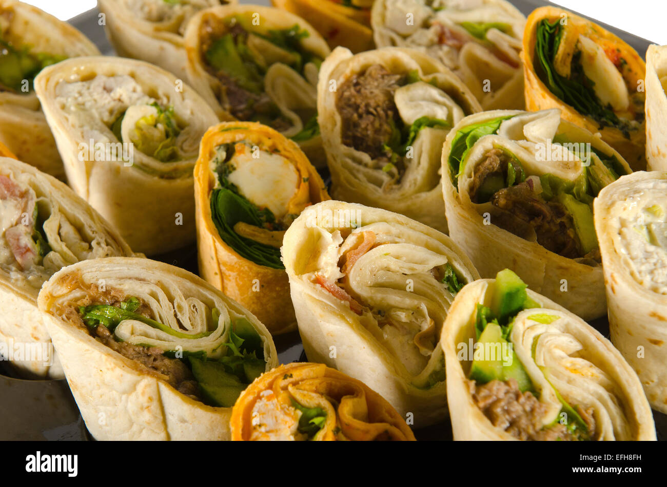 a plate of party food, wraps rolls and sandwiches Stock Photo Alamy