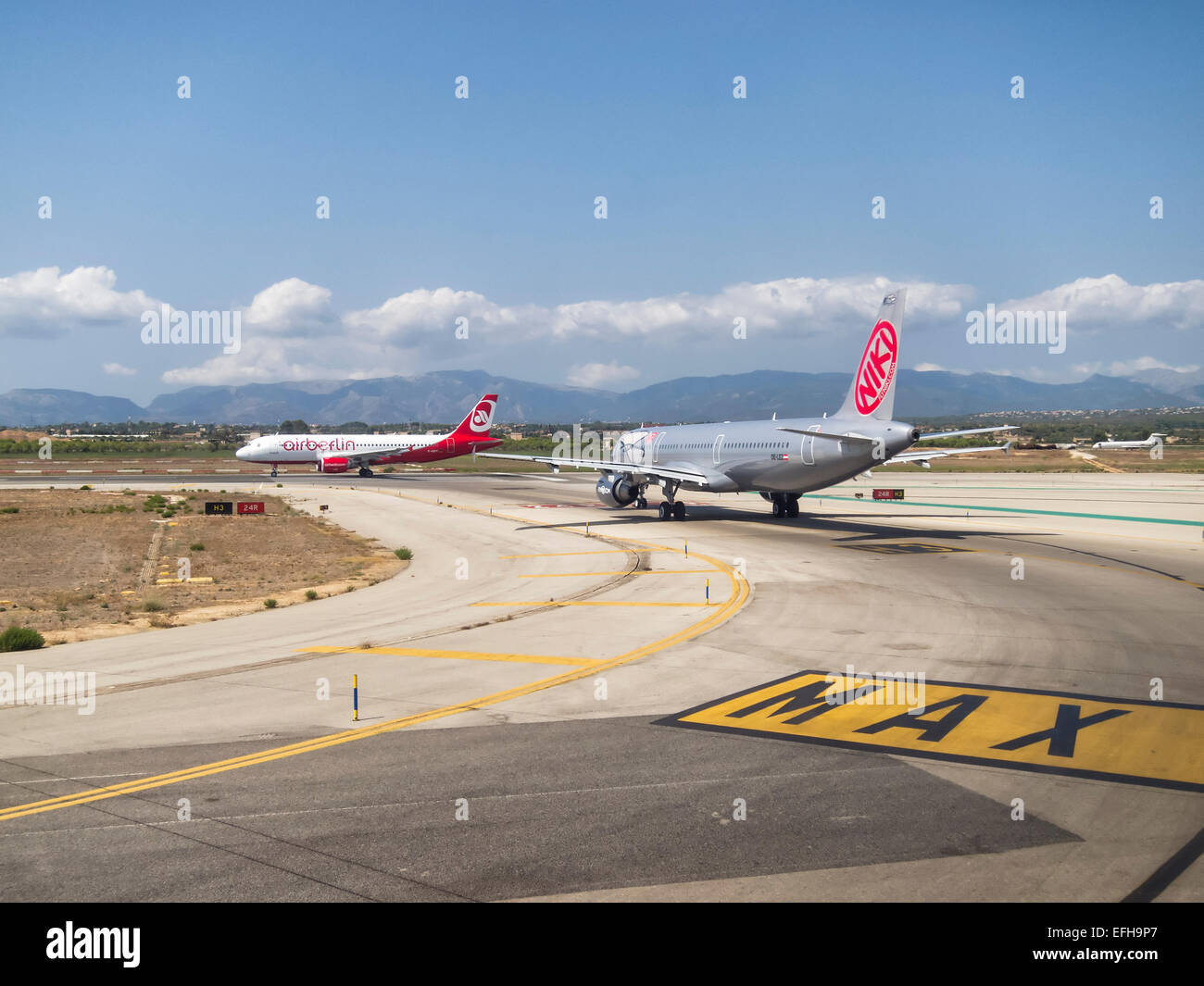Planes lined up in the taxiway waiting to enter in the runway to takeoff Stock Photo