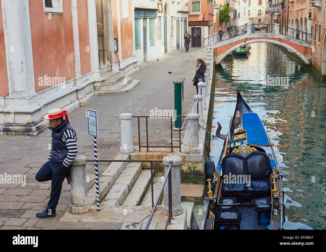 Gondolier waiting for customers next to a gondola service point Venice Veneto Italy Europe Stock Photo