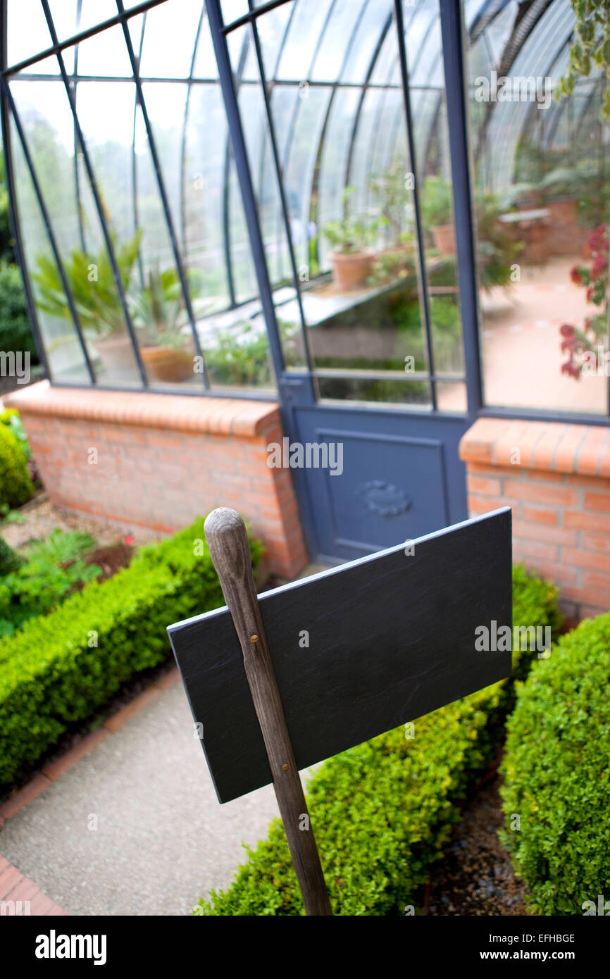 Panel in front of a green house Stock Photo