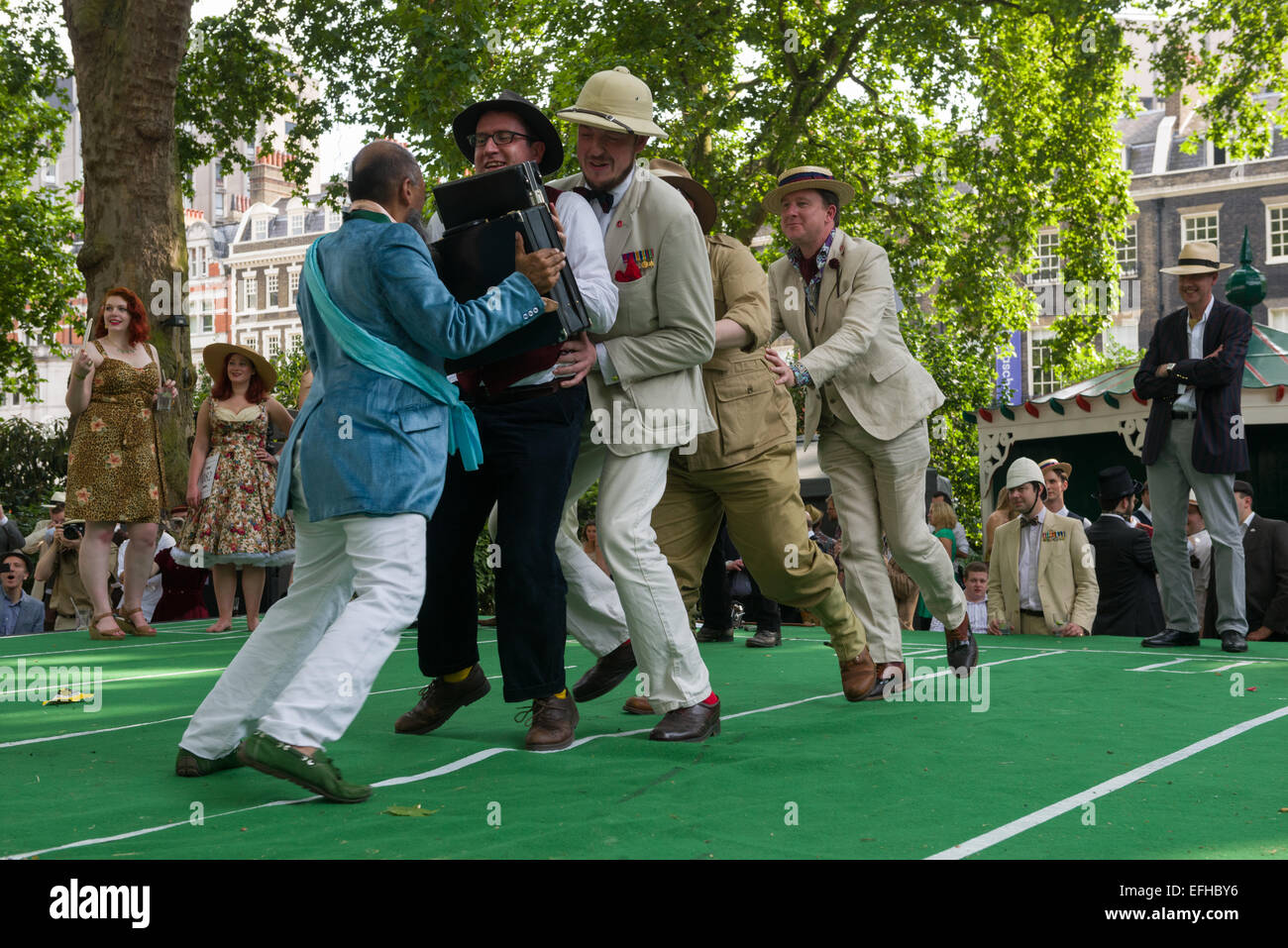 The 10 Anniversary of the Chap Olympiad. A sartorial gathering of chaps and chapesses in Bloomsbury London. Various Chap sports are held at a picnic in the square. This event is the Briefcase Phalanx: a fight with briefcases, London, England Stock Photo