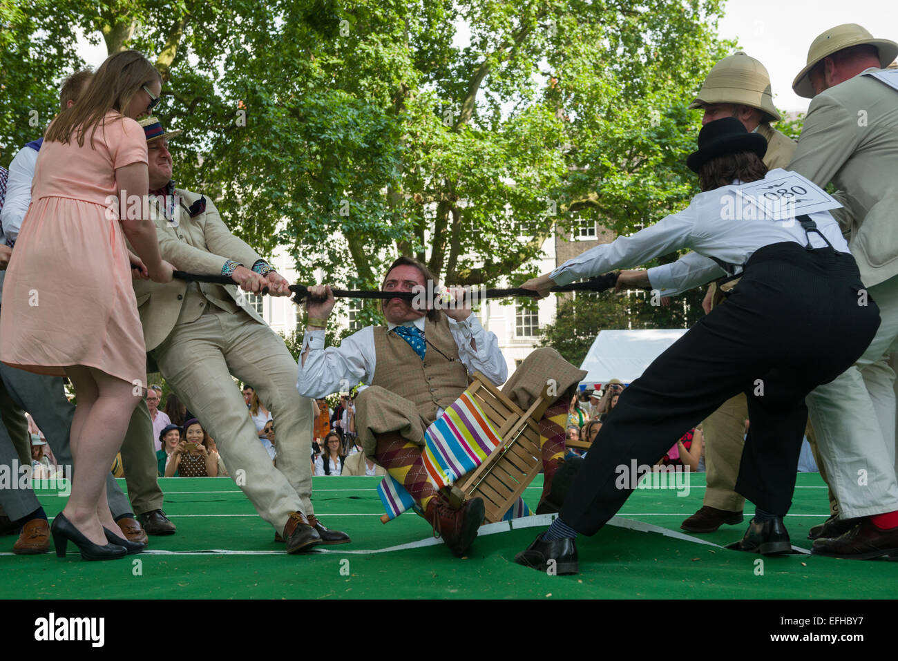 The 10 Anniversary of the Chap Olympiad. A sartorial gathering of chaps and chapesses in Bloomsbury London. Various Chap sports are held at a picnic in the square. This event is the Tug of Hair - a moustache tug of war, London, England Stock Photo