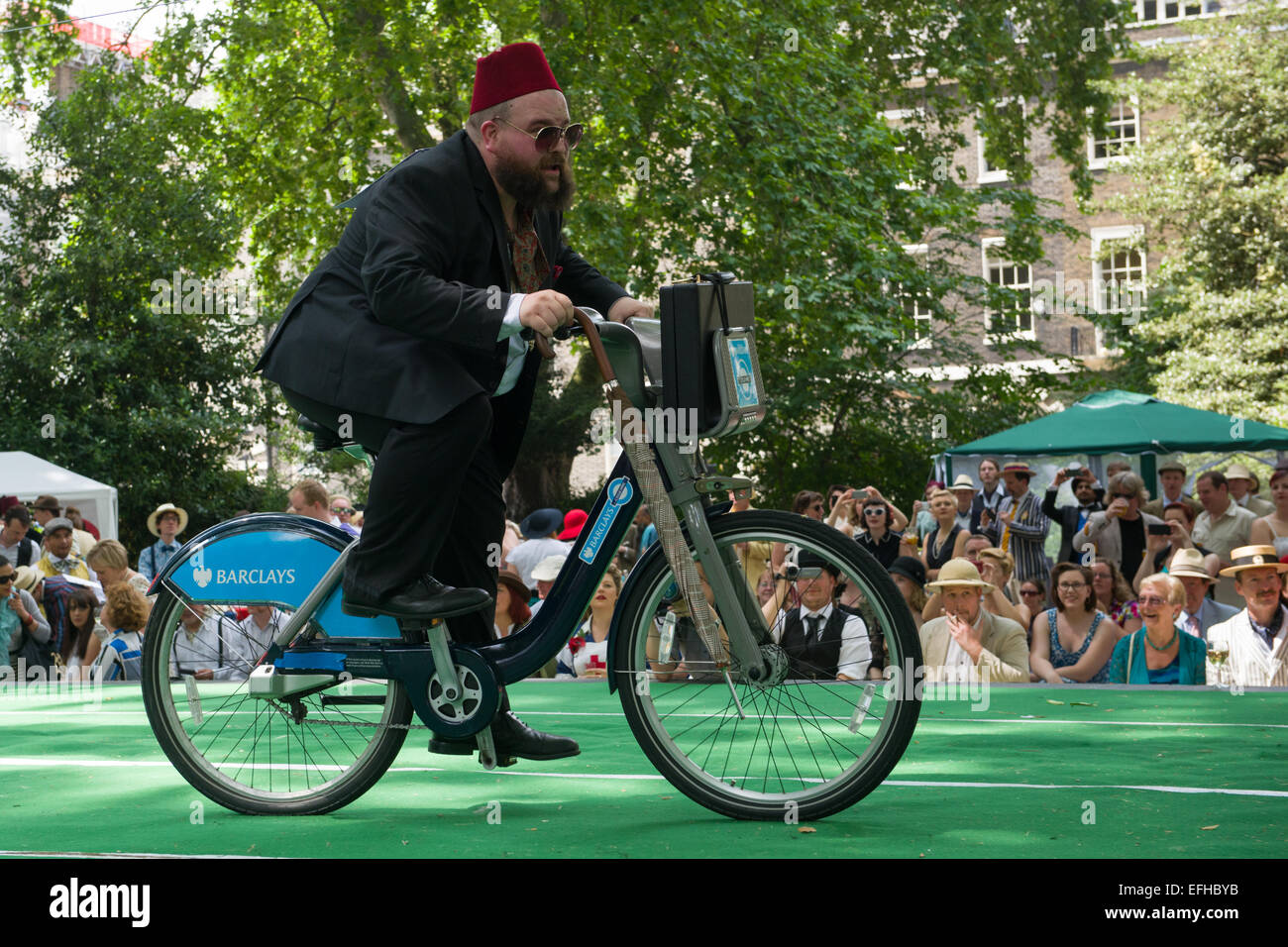 The 10 Anniversary of the Chap Olympiad. A sartorial gathering of chaps and chapesses in Bloomsbury London. Various Chap sports are held at a picnic in the square. Here people compete in the Umbrella Jousting, London, England Stock Photo