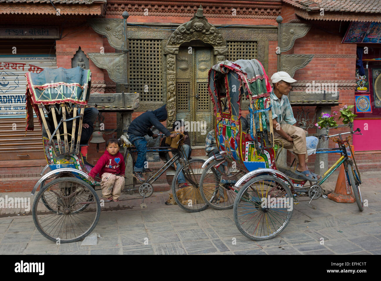 Small child sitting on a cycle-rickshaw, Kathmandu, Kathmandu Valley, Nepal Stock Photo