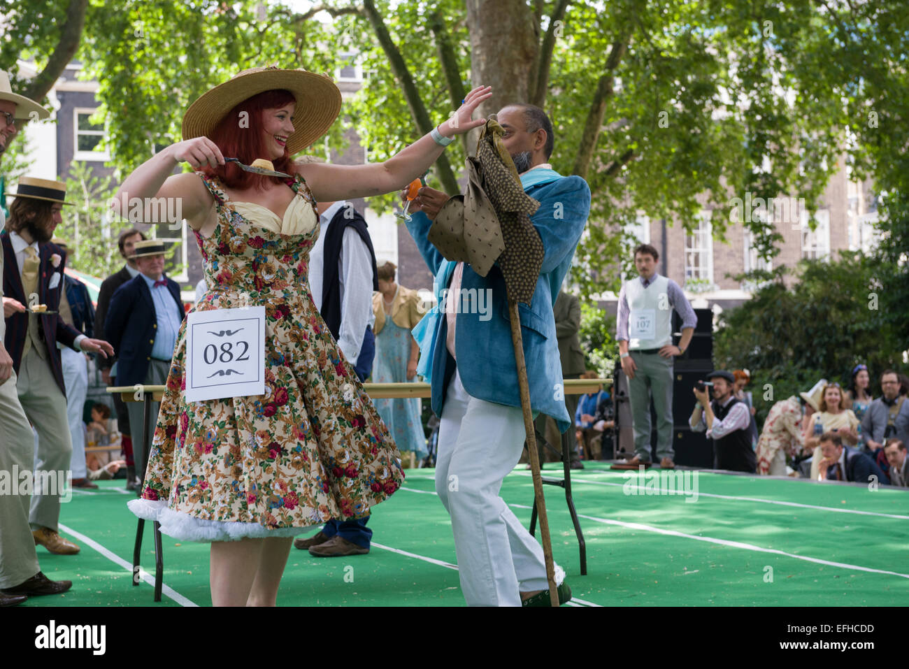 The 10 Anniversary of the Chap Olympiad. A sartorial gathering of chaps and chapesses in Bloomsbury London. Here people take part in the  Bakewell Battles - fighting to make each other drop  slices of Bakewell Tarts, London, England Stock Photo