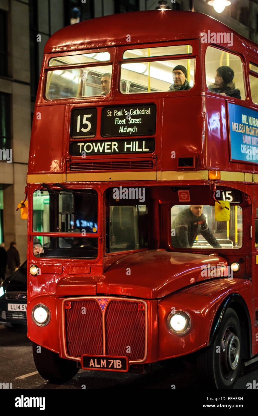 Night image of old double decker bus in London street. Stock Photo