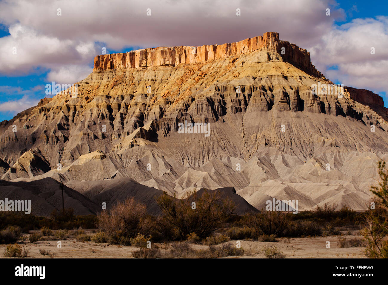 Factory Butte is made from Emery sandstone layered over Blue Gate shale, near Capitol Reef National Park, Hanksville, Utah Stock Photo