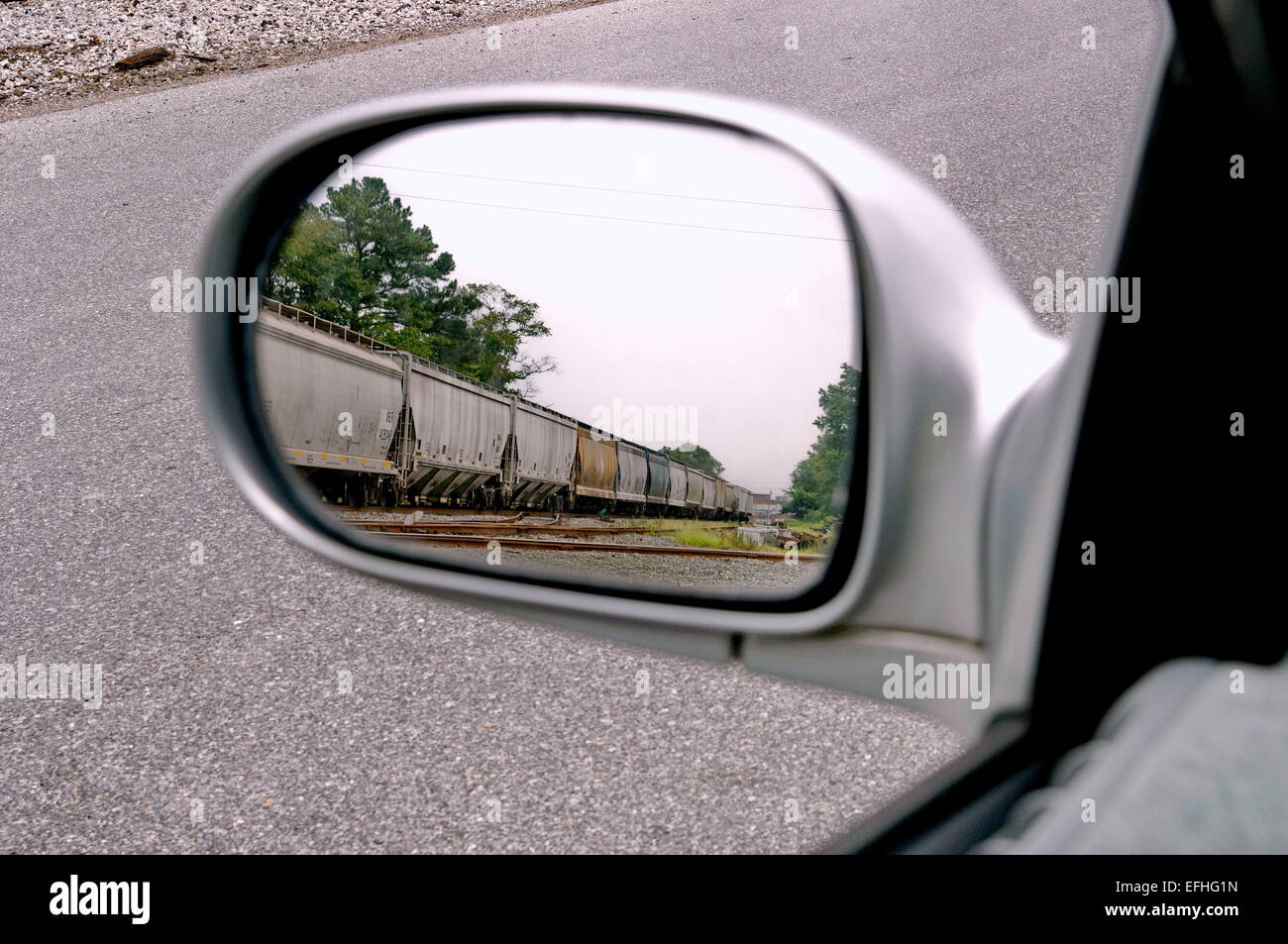Freight train in driver side mirror Stock Photo Alamy