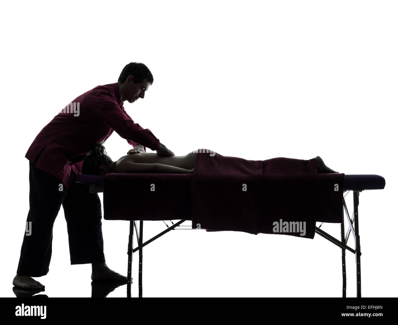 man woman back massage in silhouette studio on white background Stock