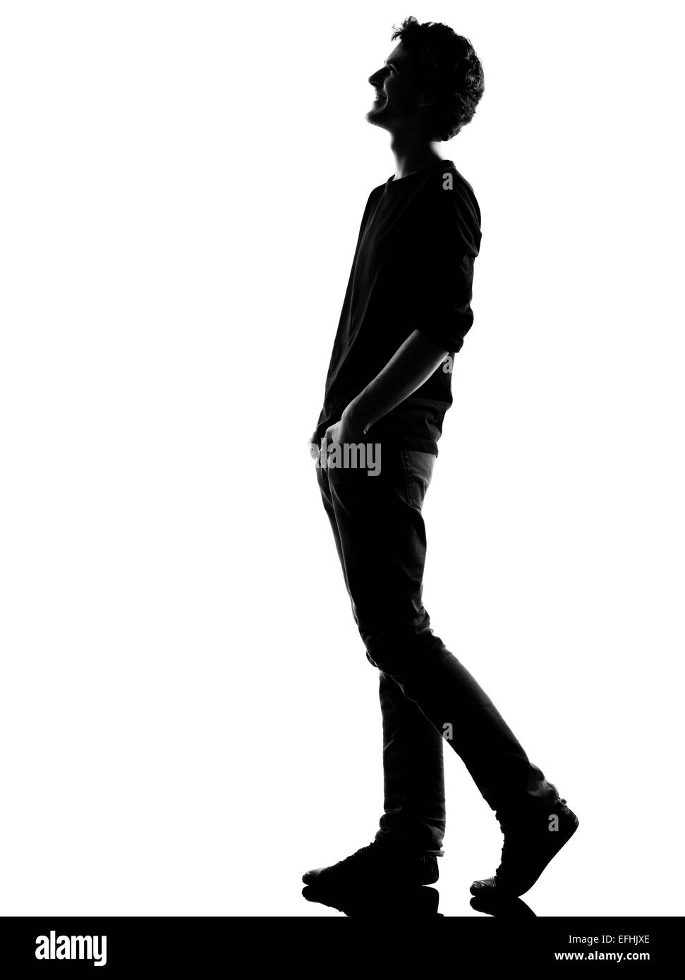 young man walking happy laughing silhouette in studio isolated on white ...