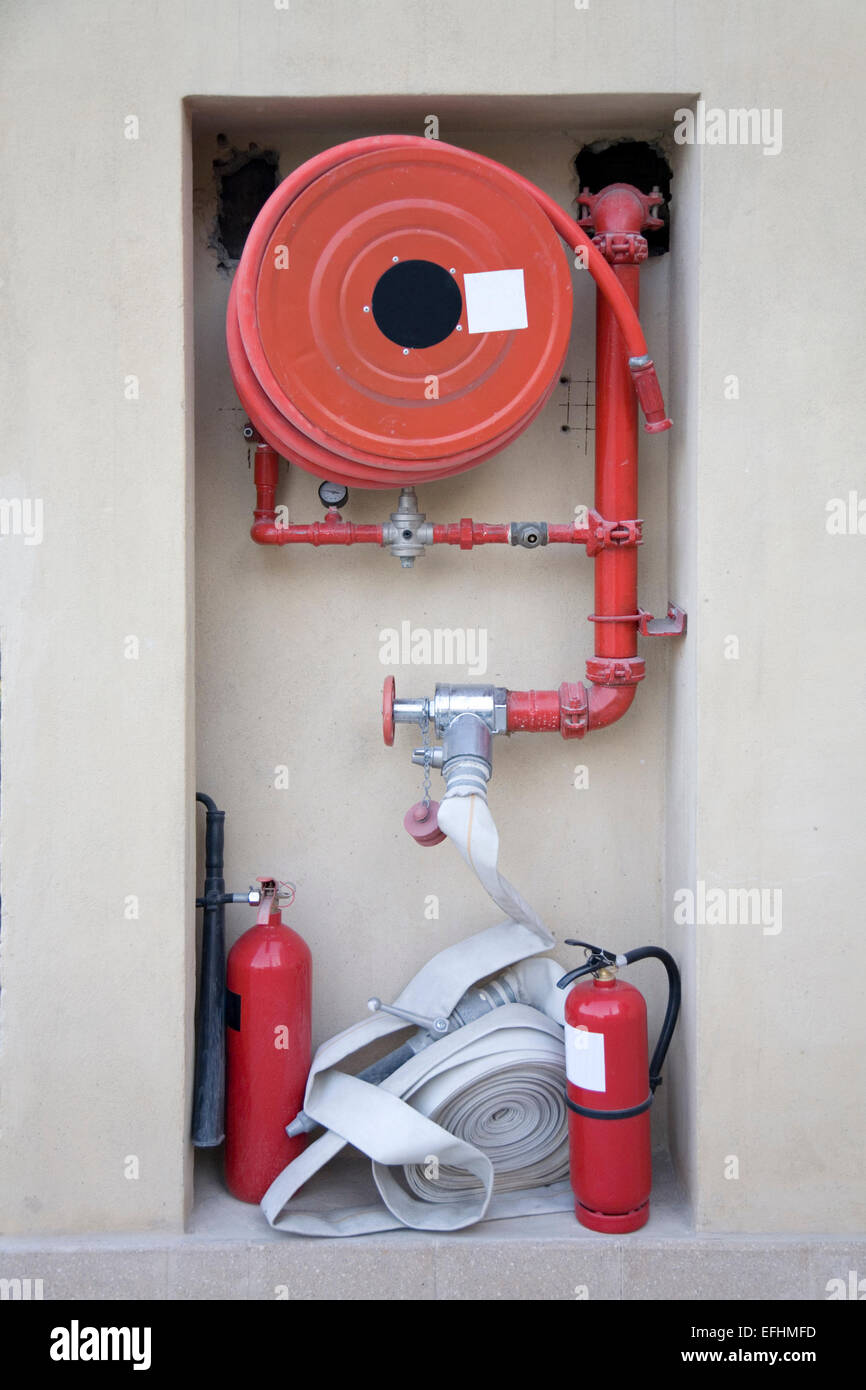 Firefighting equipment - hose reel and fire extinguishers at an underground car park Stock Photo