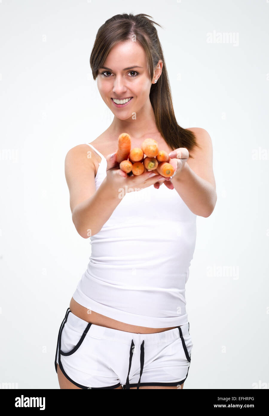 Healthy lifestyle! Beautiful woman holding carrot Stock Photo