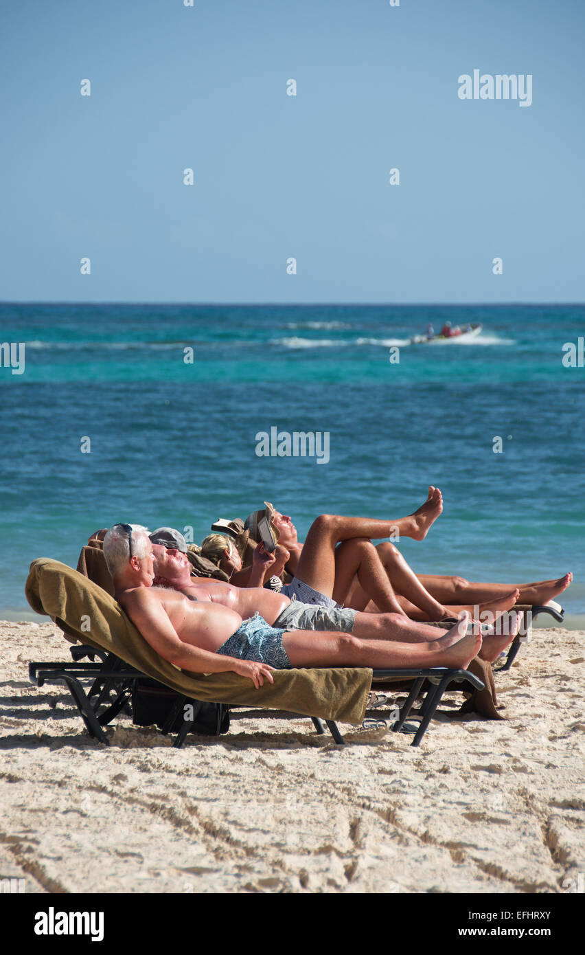 DOMINICAN REPUBLIC. Sunbathers on Punta Cana beach. 2015. Stock Photo