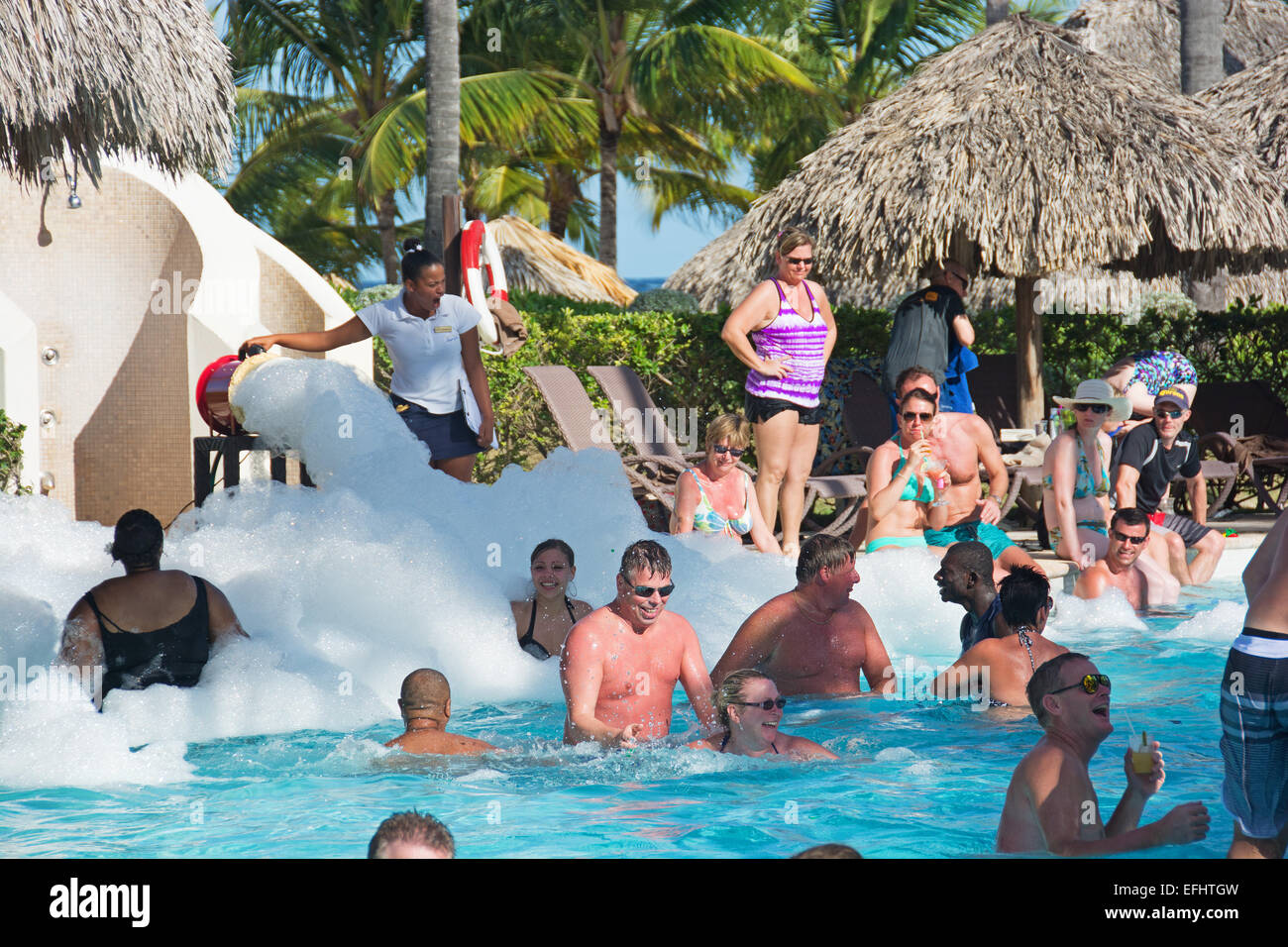 PUNTA CANA, DOMINICAN REPUBLIC. Holidaymakers at a swimming pool foam party. 2015. Stock Photo