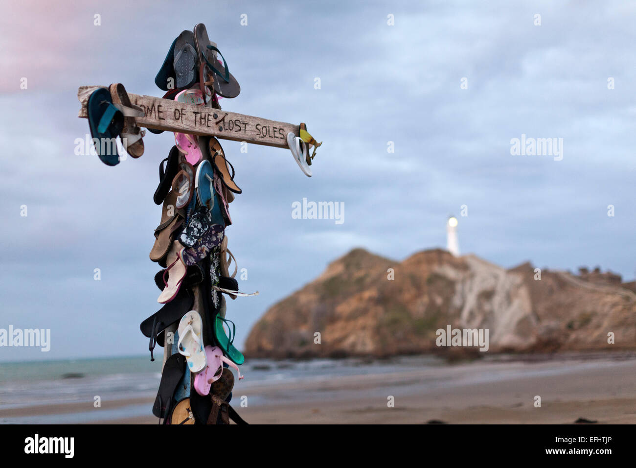 Cross with sandals, Home of the lost soles, humour on the beach, Castle Point, East coast, Wairarapa, North Island, New Zealand Stock Photo