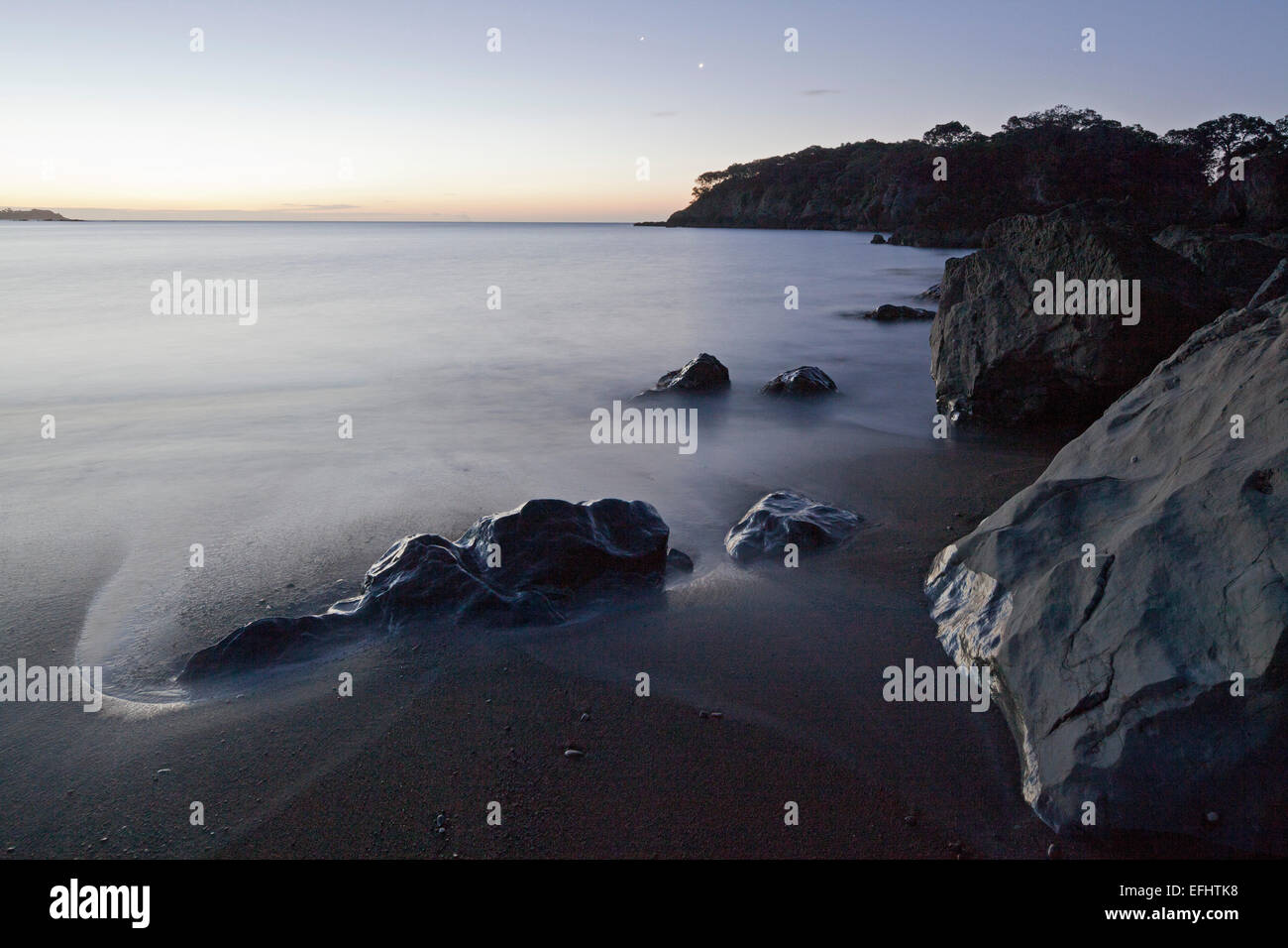 Rocky coastline at dusk, Whanarua Bay, East Cape, North Island, New Zealand Stock Photo