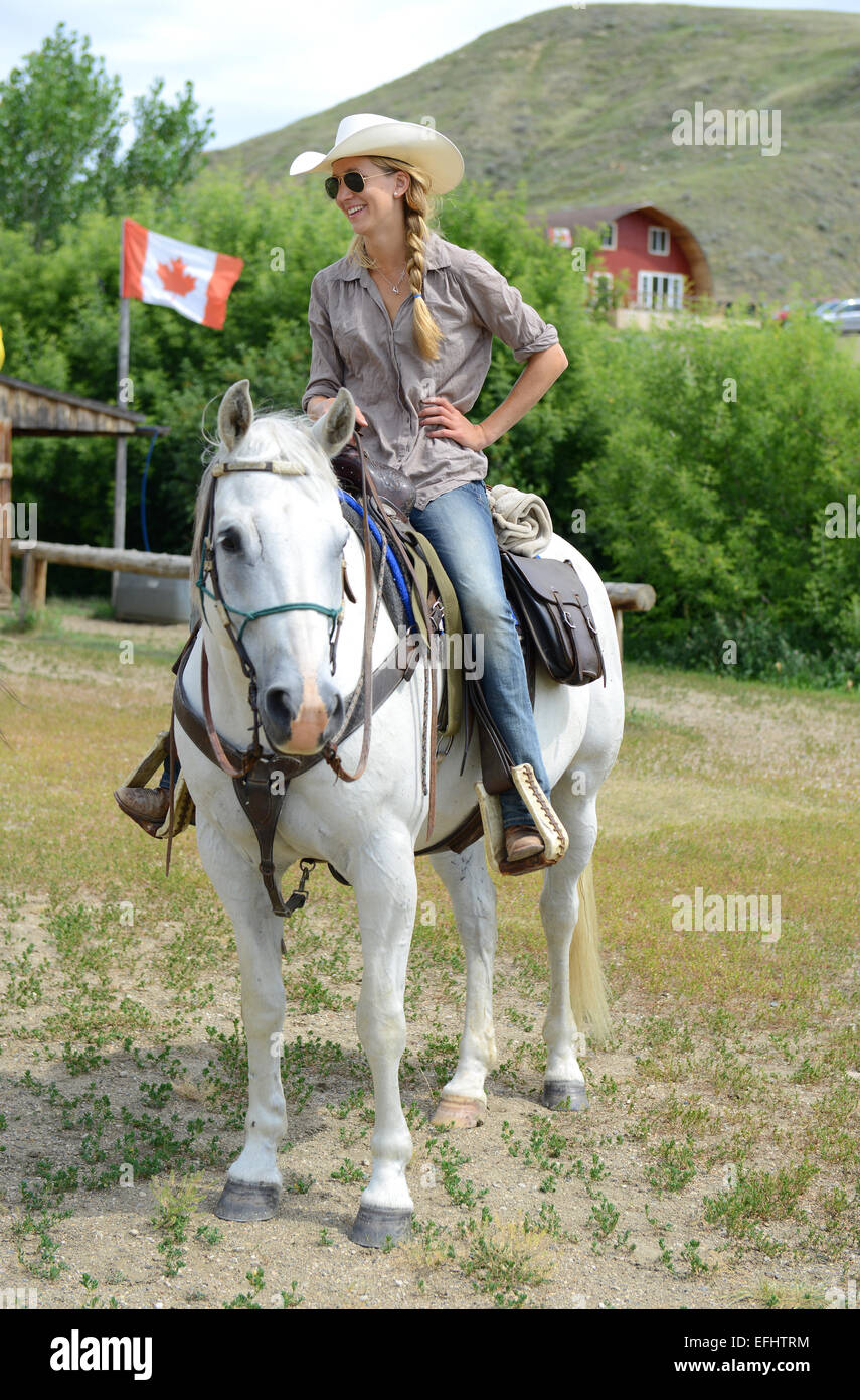 Woman on horseback, La Reata Ranch, Saskatchewan, Canada. Stock Photo
