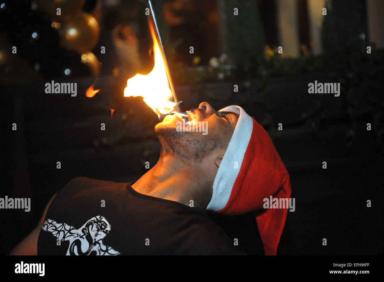 Fire eater entertainment at an opening party night. Stock Photo