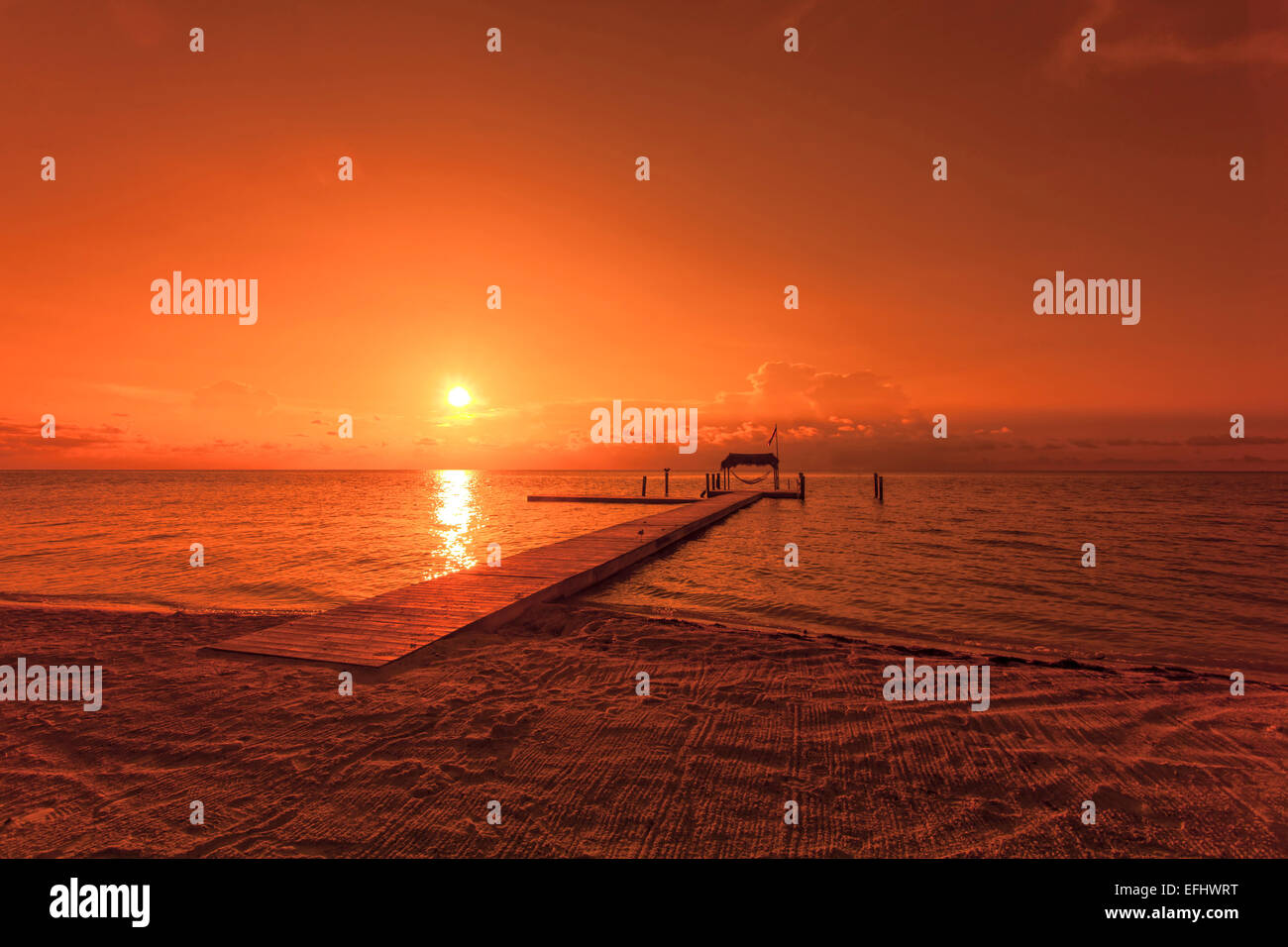 Beach with landing stage in the morning light at sunrise, Moorings Village Resort, Islamorada, Florida Keys, Florida, USA Stock Photo