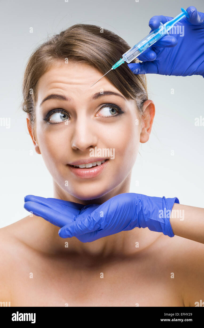 Beautiful woman with plastic surgery, the fear of the needle Stock Photo