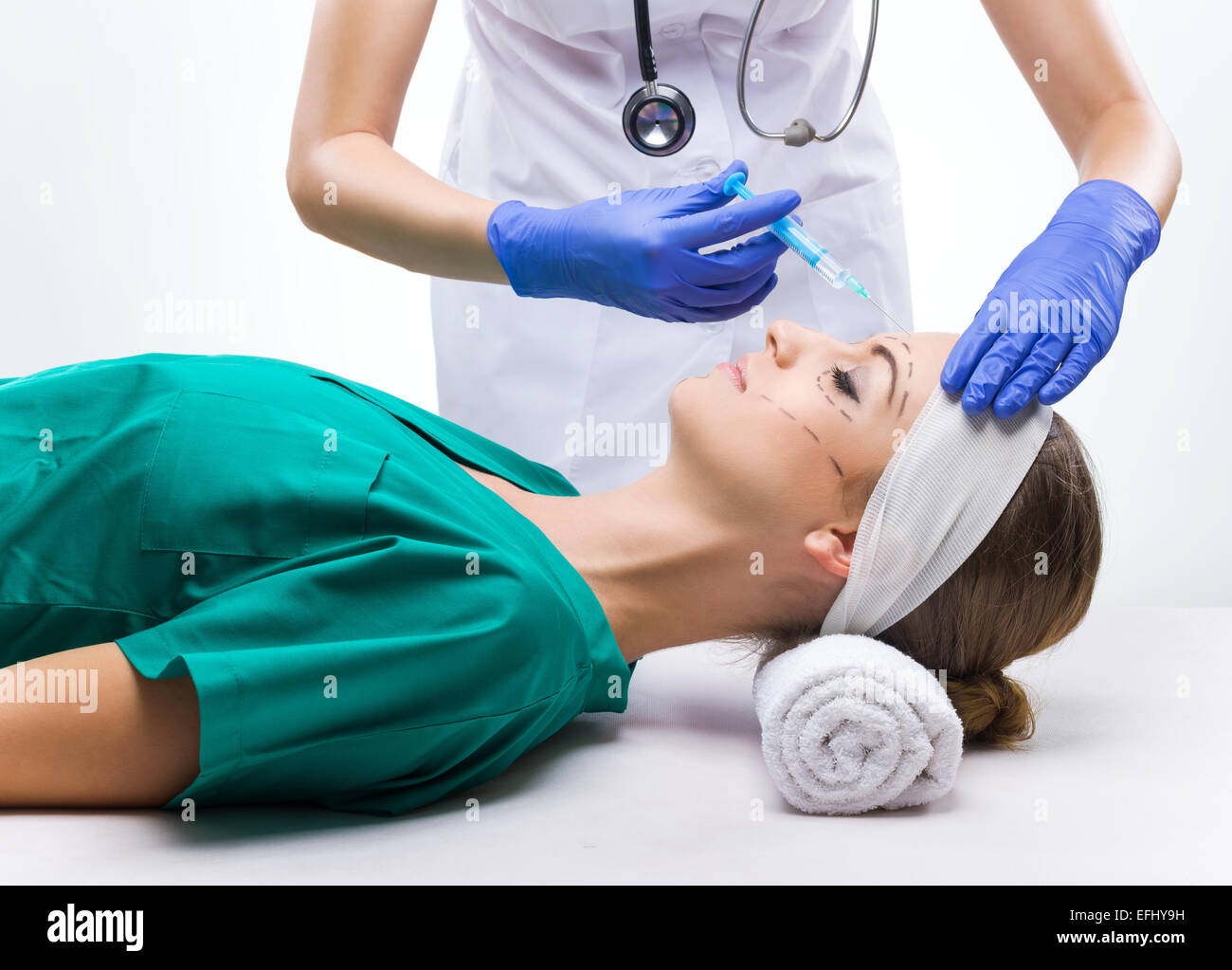 Plastic surgery - Beautiful woman, before surgery, surgical gown lying on the bed Stock Photo