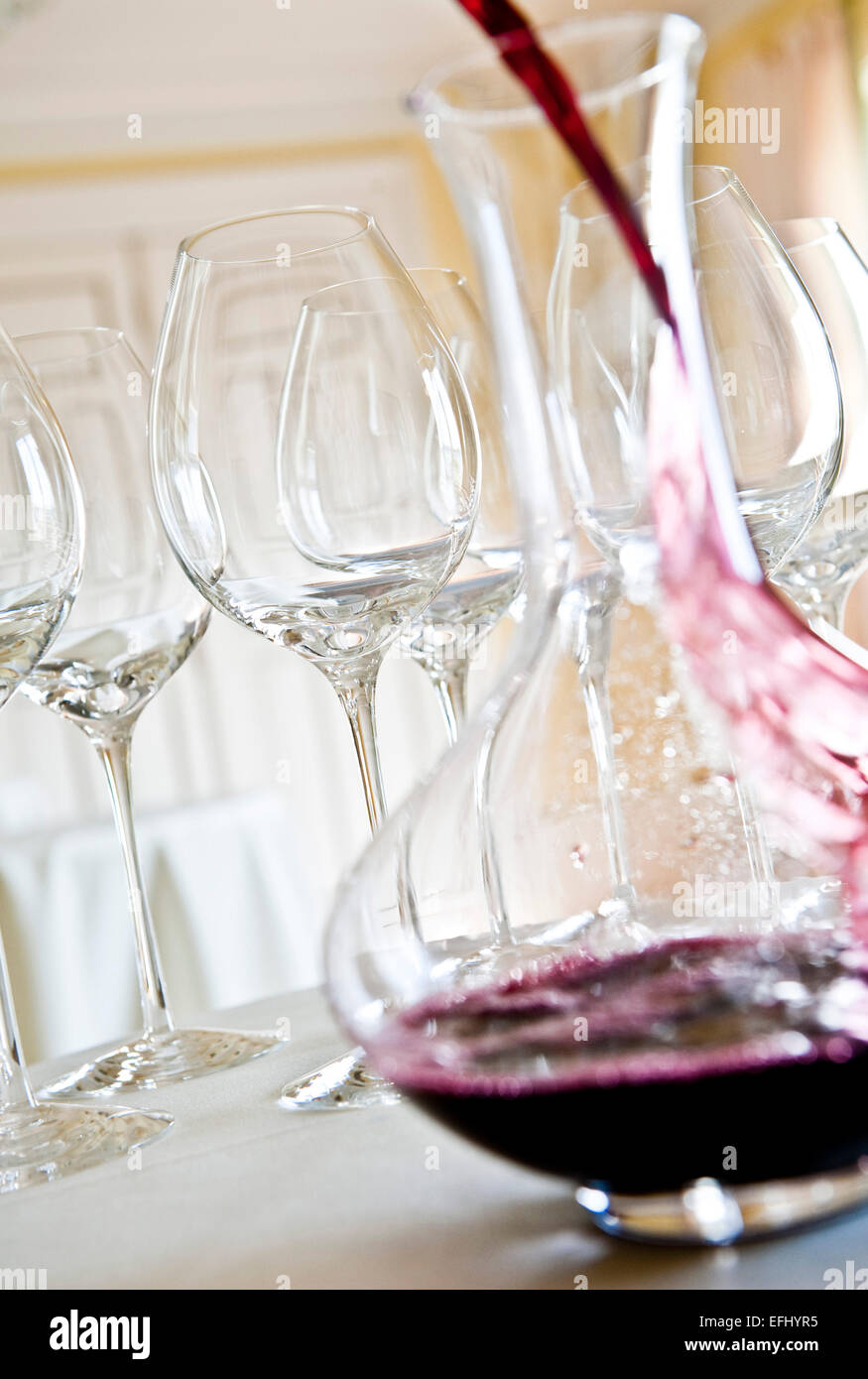 Red wine being poured into a decanter, Red wine glasses, Hamburg