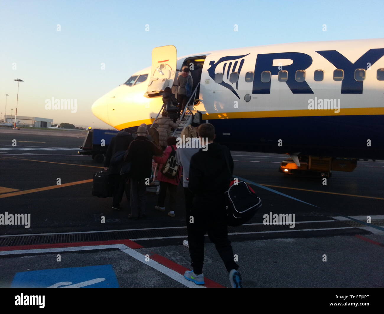 Holiday makers board a Ryan Air Boeing 737 at Manchester airport Stock Photo