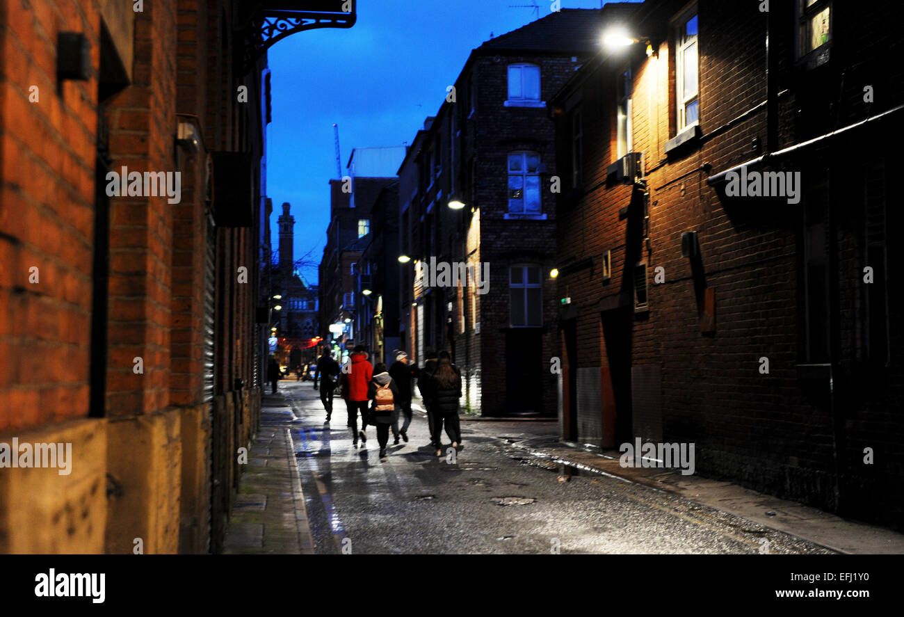 Manchester Lancashire UK - People walking along dark street in The Canal Street district of Manchester Stock Photo