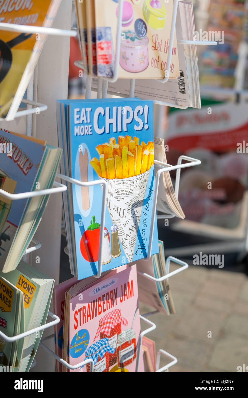 BRIGHTON, UK- JULY 28: Eat more chips postcard in a postcard rack on the seafront in Brighton, july 2013. Stock Photo