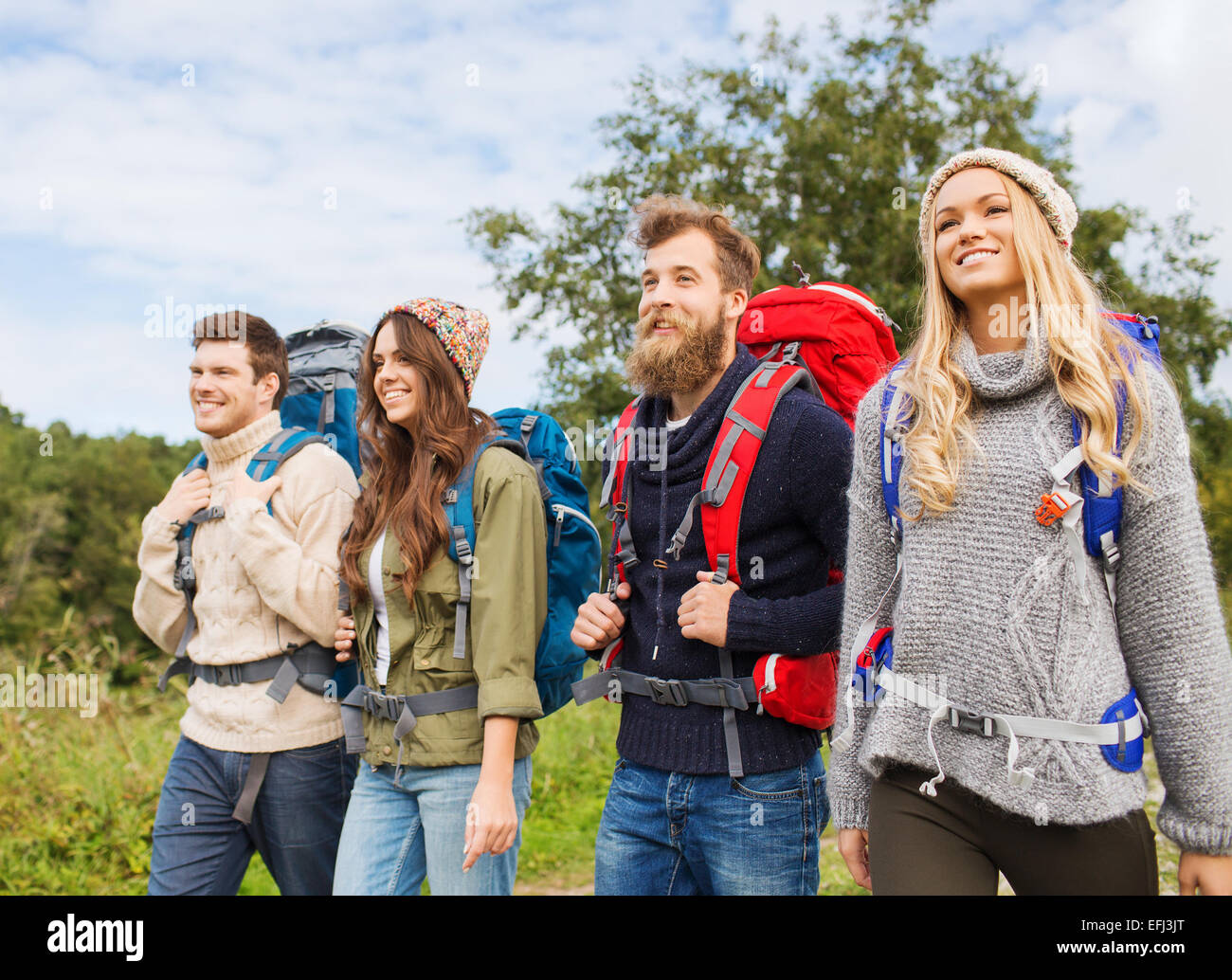 group of smiling friends with backpacks hiking Stock Photo - Alamy
