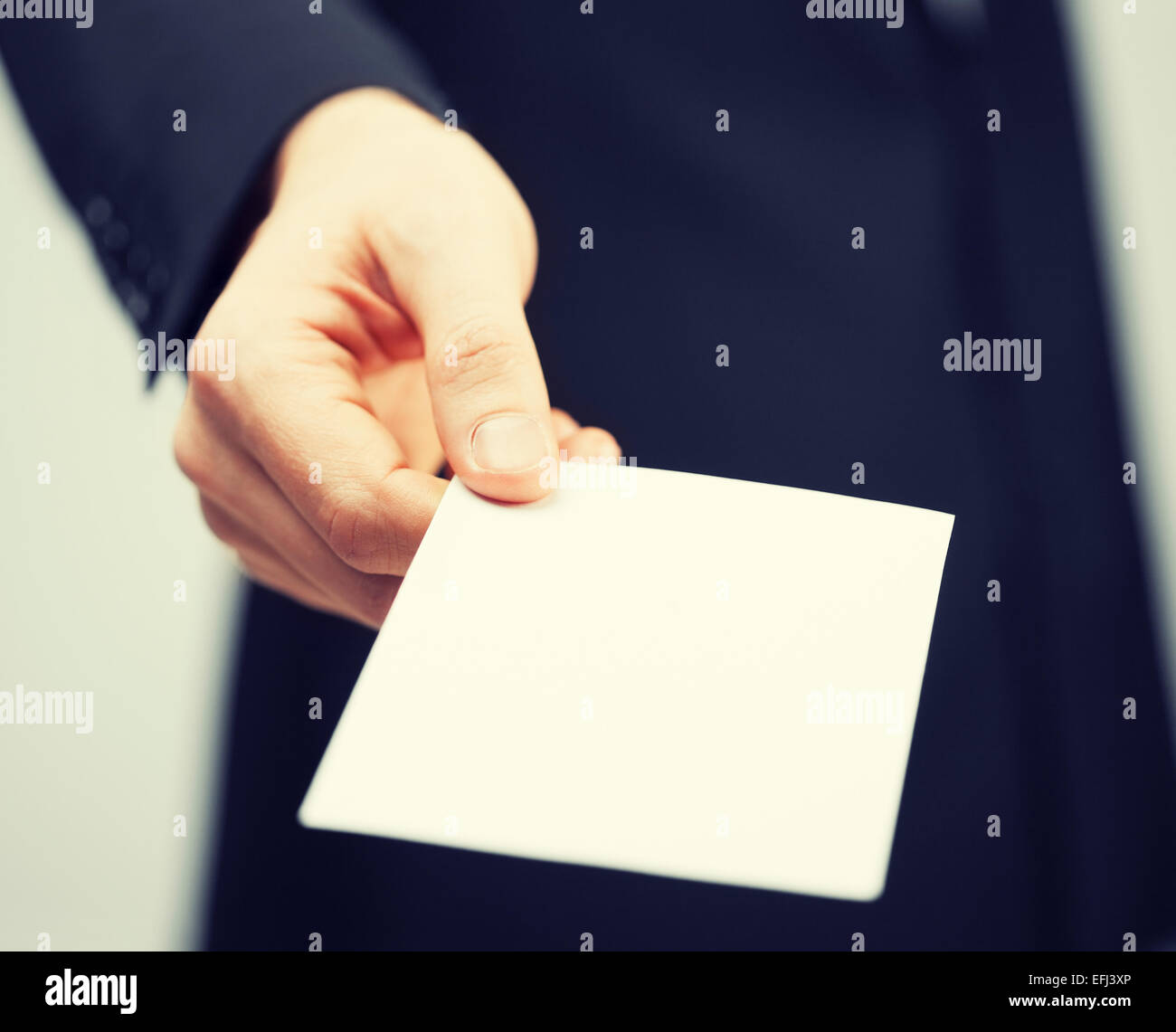 man in suit holding credit card Stock Photo