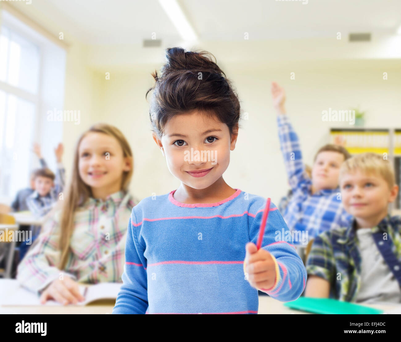 happy little school girl over classroom background Stock Photo - Alamy