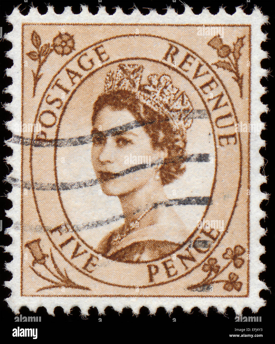 UNITED KINGDOM - CIRCA 1952 to 1965: An English Five Pence Brown Used Postage Stamp showing Portrait of Queen Elizabeth 2nd, cir Stock Photo