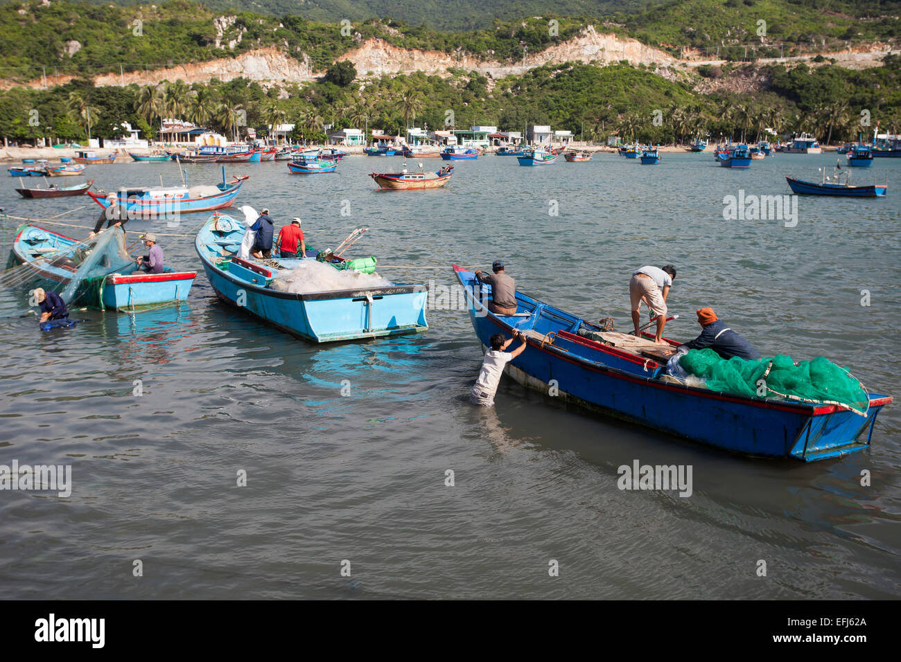 Fishermen in their fishing boats unloading their catch, Vinh Hy Bay, South China Sea, Vietnam Stock Photo