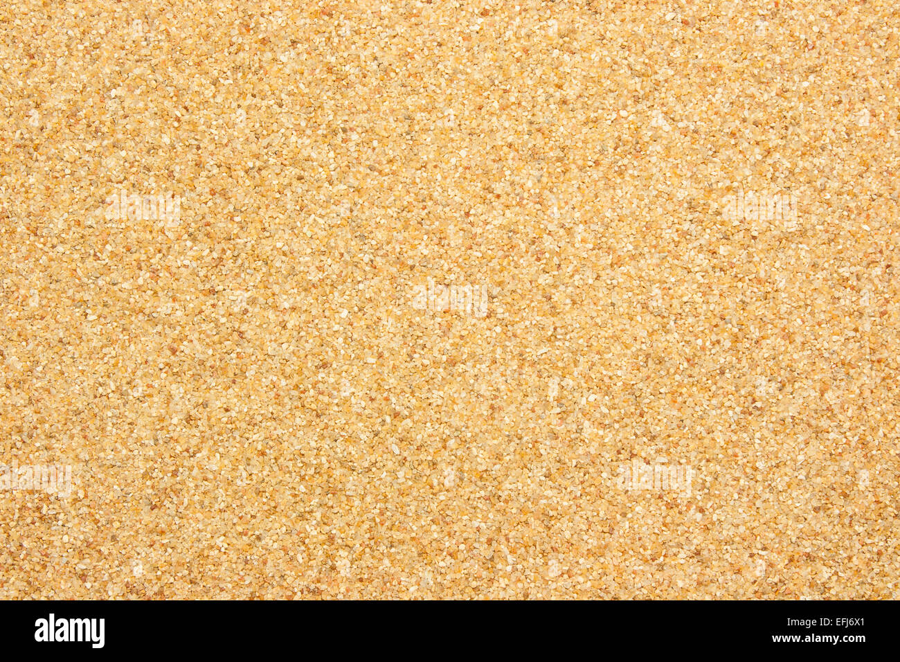 Closeup view from the top of coarse river sand which is light red in color. Stock Photo