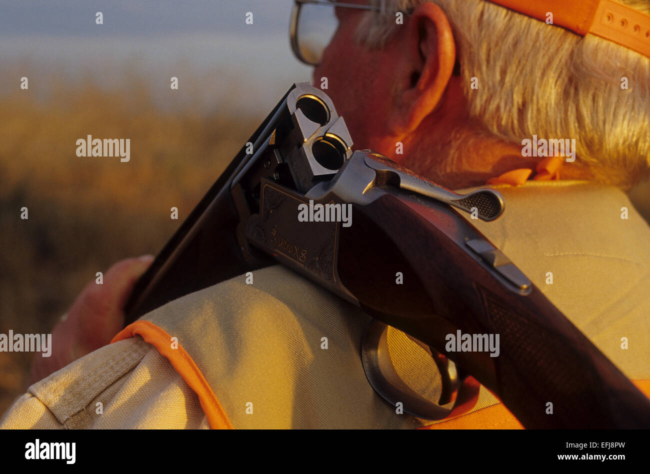 A hunter with an over and under shotgun while quail hunting on the King