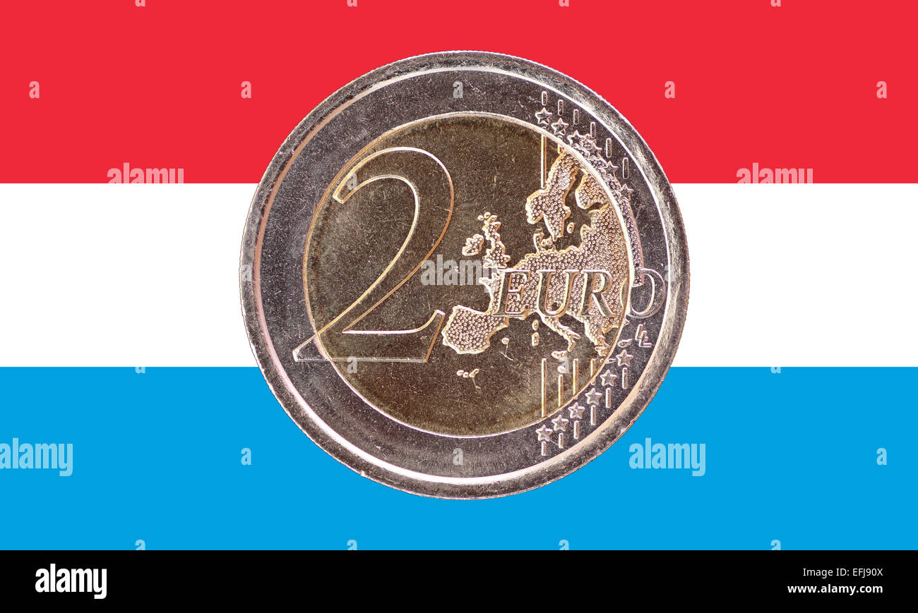 Common face of two euros coin isolated on the national flag of Luxembourg as background Stock Photo