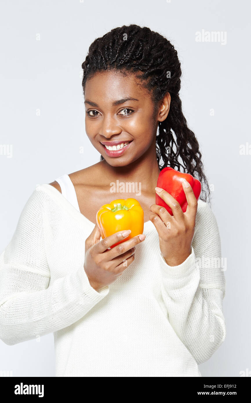 Ethnic girl holding peppers Stock Photo