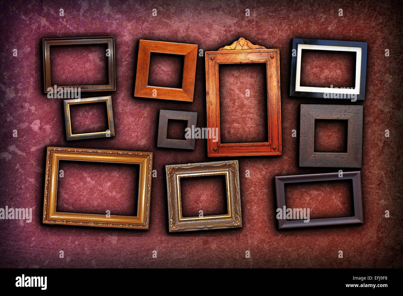 beautiful backdrop with vintage frames on scratched red wall background Stock Photo