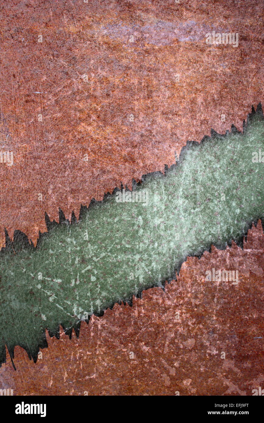 cracked rusty backdrop with green and orange scratched surfaces Stock Photo