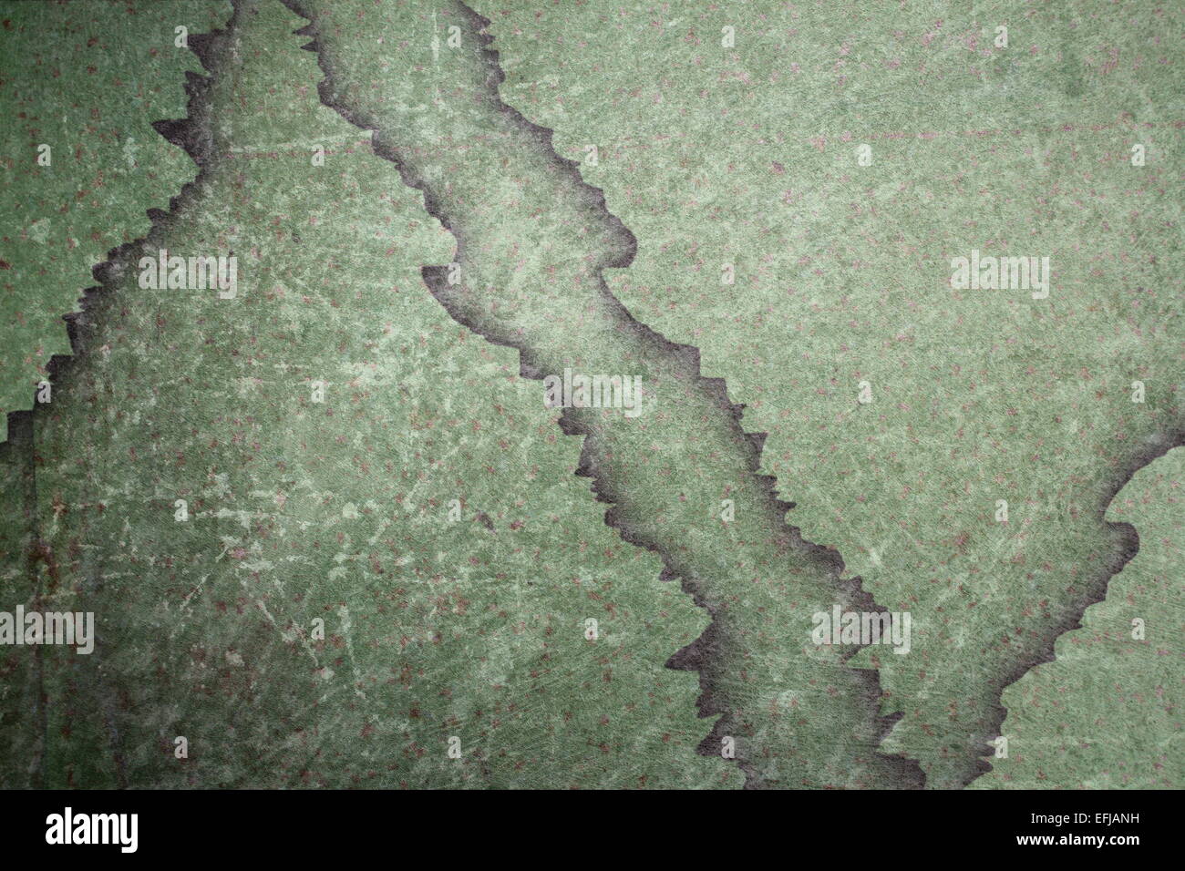green metal grungy surface with cracks and scratches Stock Photo