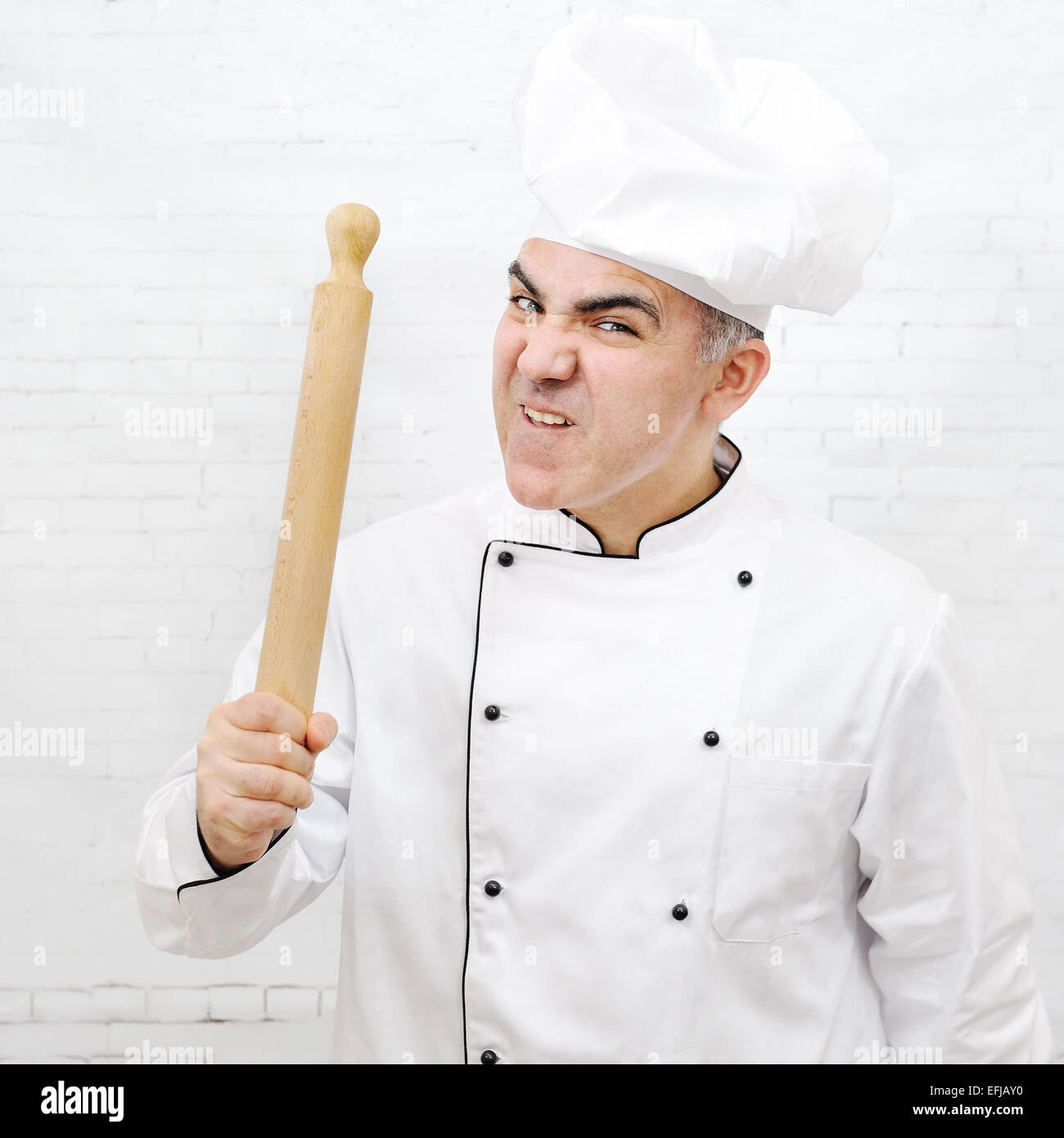 angry chef with a rolling pin Stock Photo